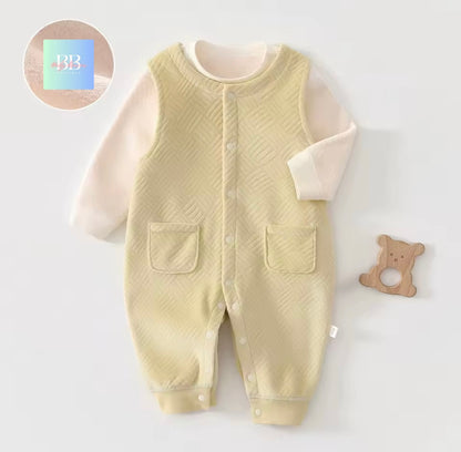 Baby romper with textured design on a light gray background