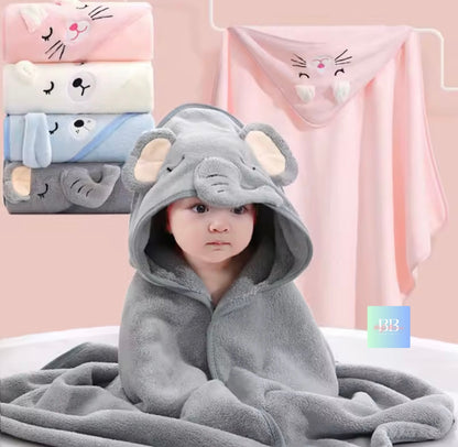 Child wearing a gray elephant hooded towel with cartoon animal designs in the background.