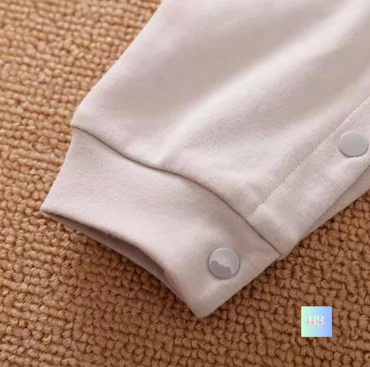 Close-up of beige fabric with buttons on a textured brown surface