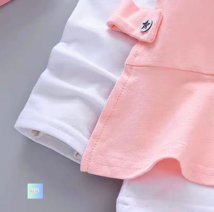 Close-up of a pink and white garment with a button on a gray background