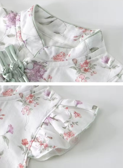 Floral-patterned outfit with ruffled details on a light gray background