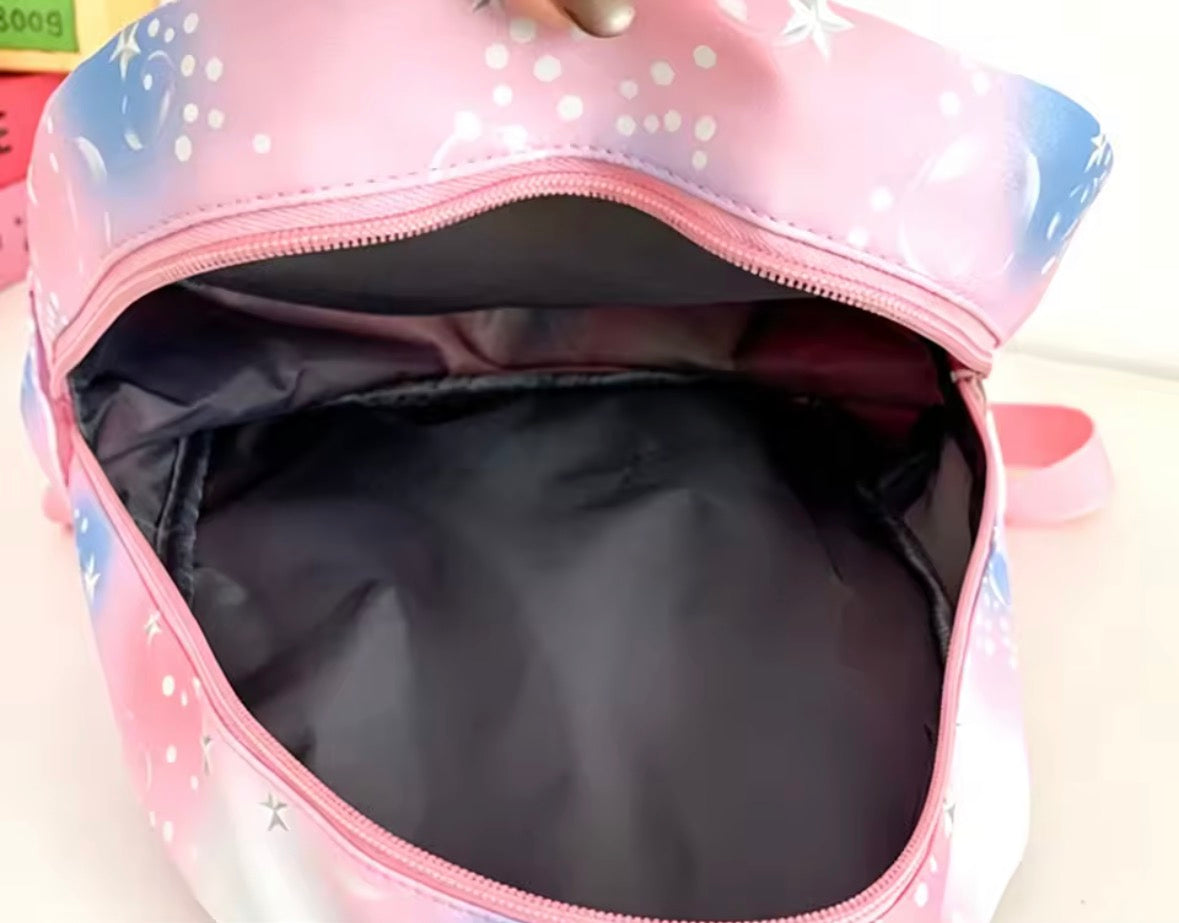 Pink backpack with a polka dot pattern on a white background
