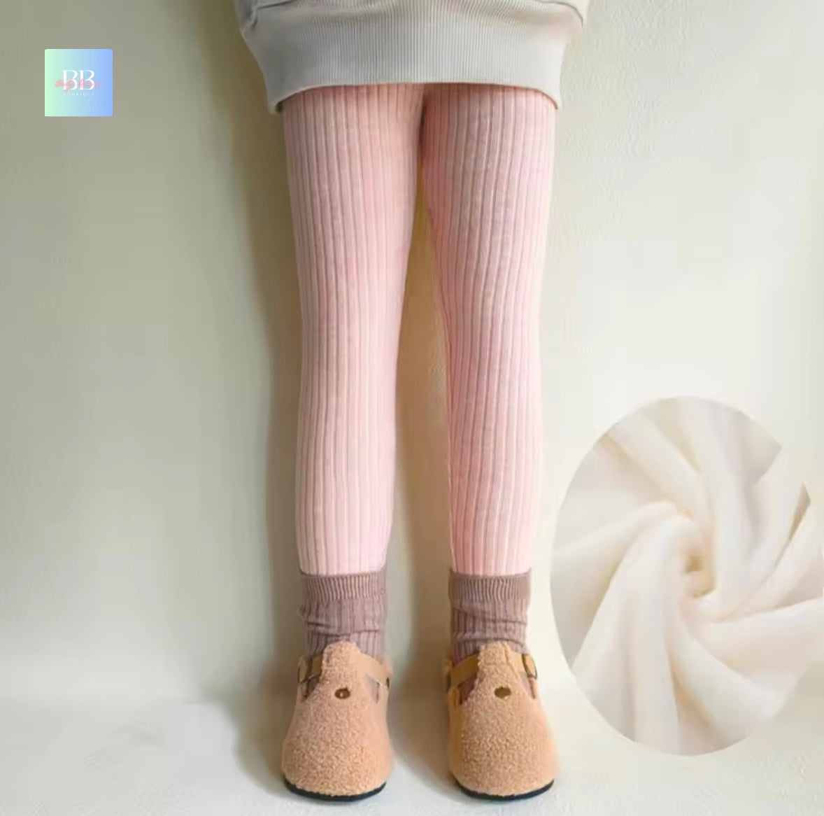 Person wearing pink tights and beige shoes with a close-up of fabric on a white background