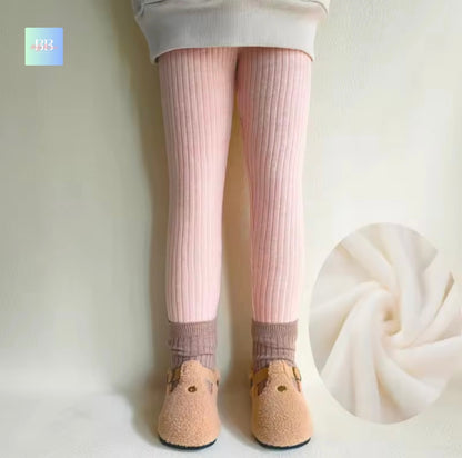 Person wearing pink tights and beige shoes with a close-up of fabric on a white background