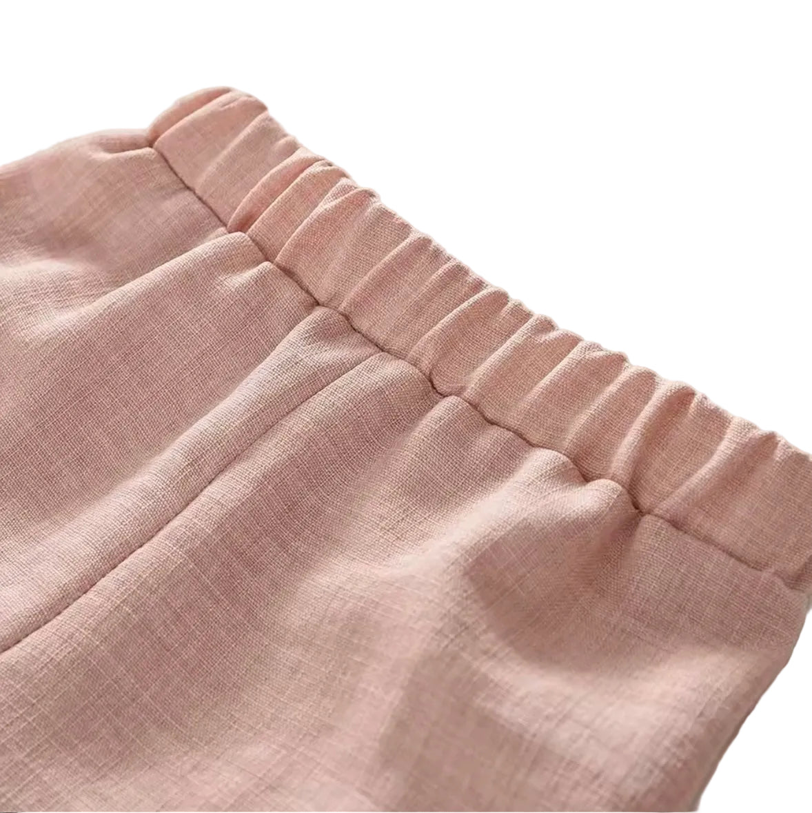 Close-up of pink fabric with a textured edge on a white background