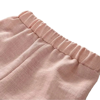 Close-up of pink fabric with a textured edge on a white background