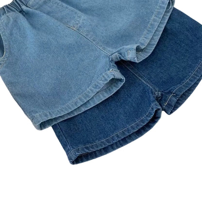 Stack of blue denim shorts on a white surface