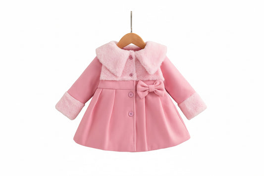 Pink children's coat with white shoes on a wooden surface