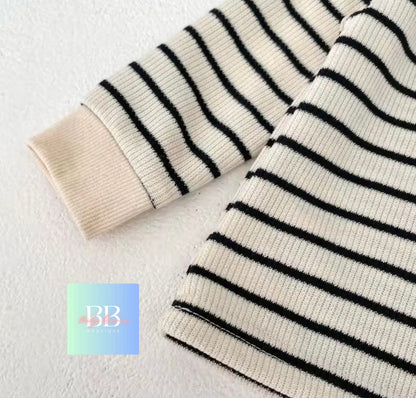 Black and white striped fabric on a light gray background with a brand logo in the corner.