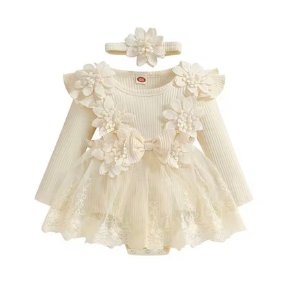 Cream-colored baby dress with floral details and matching headband on a white background
