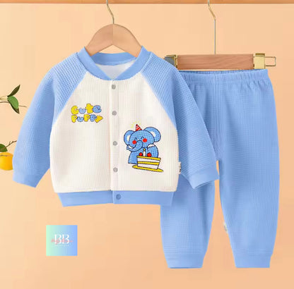 Children's blue and white outfit with cartoon design on a beige background