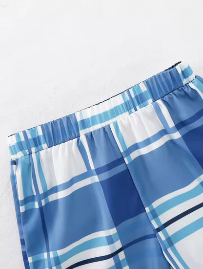 Blue and white plaid shorts on a light gray background