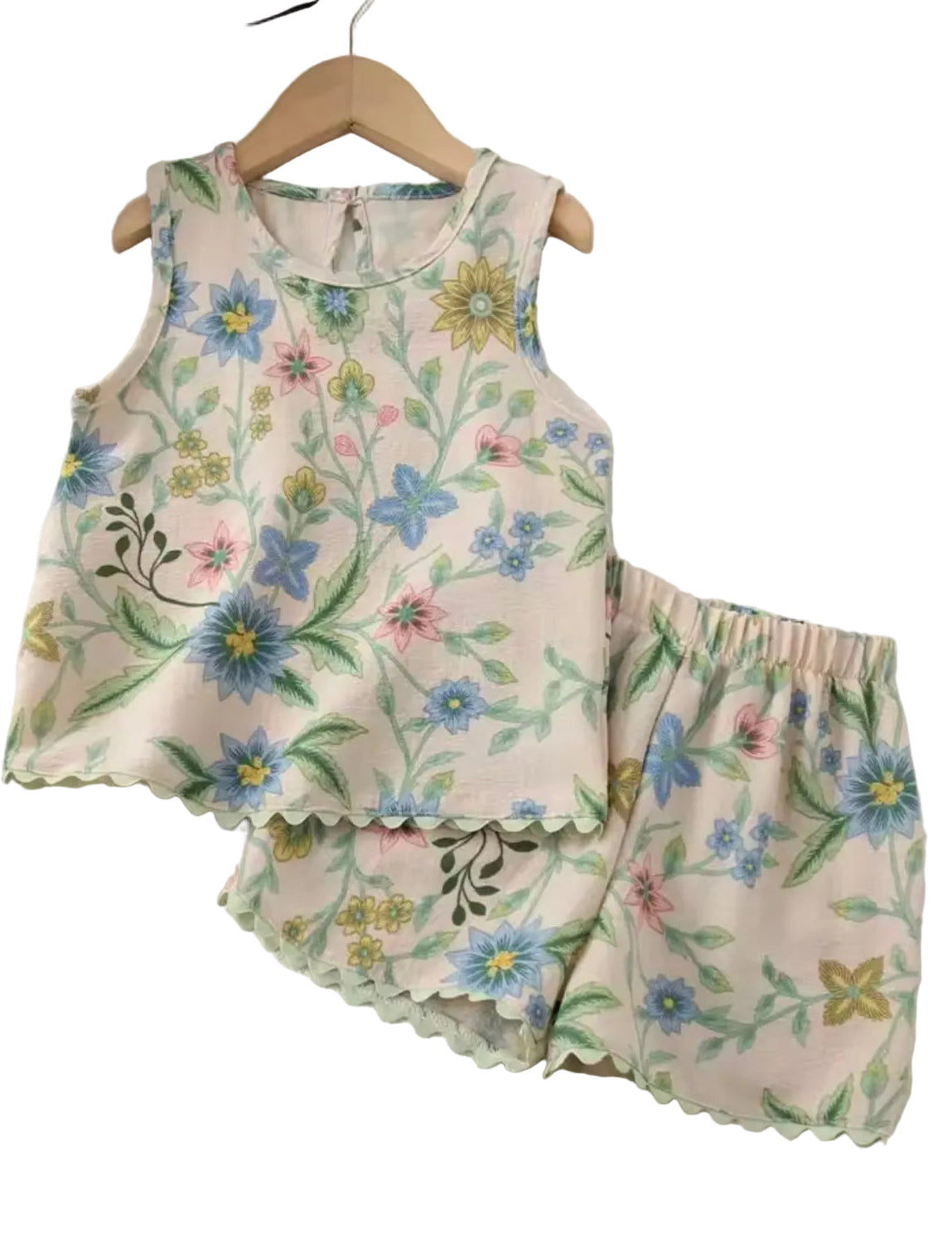 Floral-patterned children's outfit on a hanger against a white background