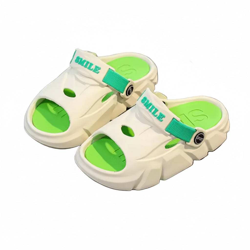 White sandals with green soles on a gray surface