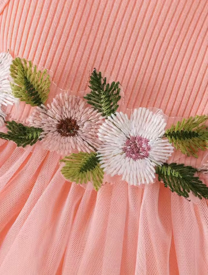 Close-up of a pink fabric with floral embroidery