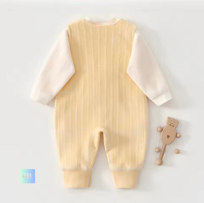 Beige baby romper with white sleeves on a light gray background