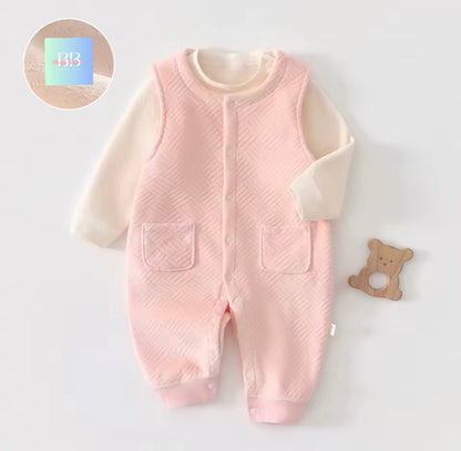 Pink baby romper with white sleeves on a light gray background
