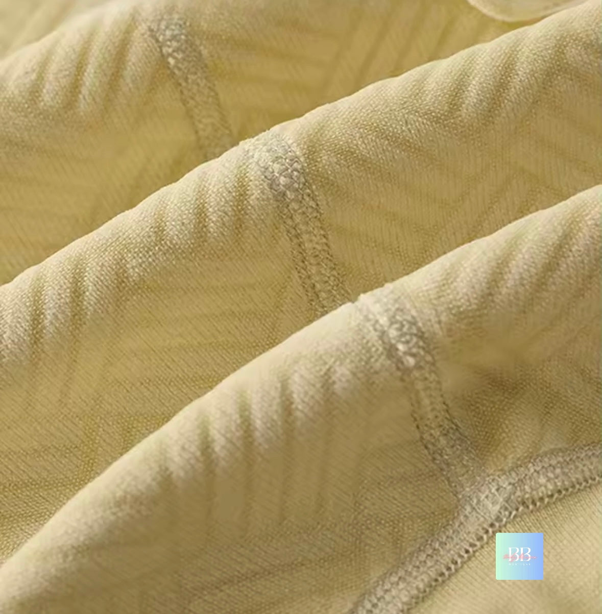 Close-up of textured beige fabric with a focus on texture and color.