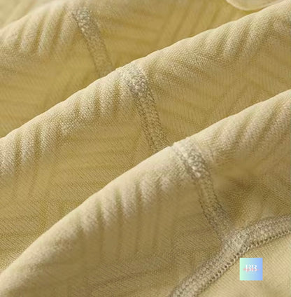 Close-up of textured beige fabric with a focus on texture and color.