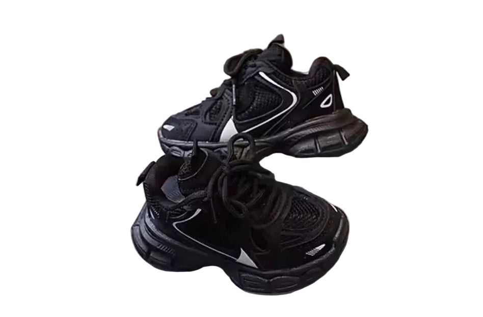 Black sneakers on a white platform with a wooden floor background
