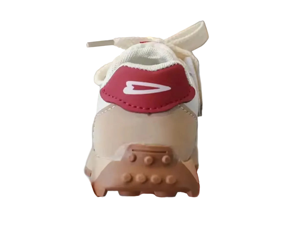 Small model of a sneaker with a red swoosh logo held by a hand.