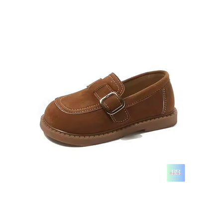 Brown children's shoe with a buckle on a white background
