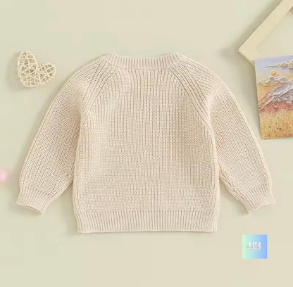 Beige knitted sweater on a light beige background