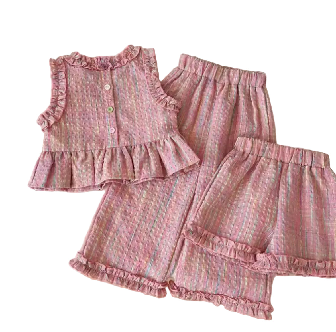 Pink children's outfit with ruffles on a white surface