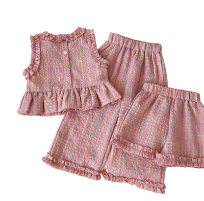 Pink children's outfit with ruffles on a white surface