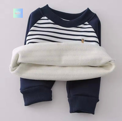 Folded baby outfit with navy and white striped top and pants on a light gray background