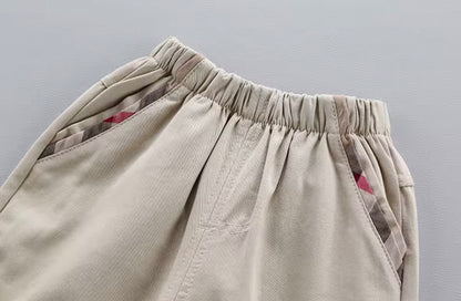 Close-up of beige pants with an elastic waistband on a gray background