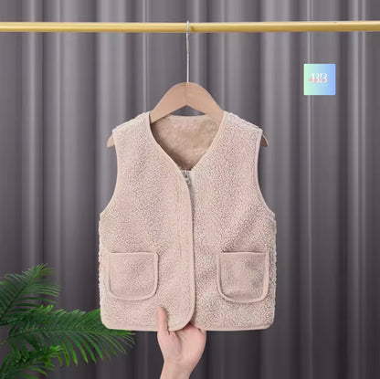 Beige fleece vest on a hanger against a gray curtain background