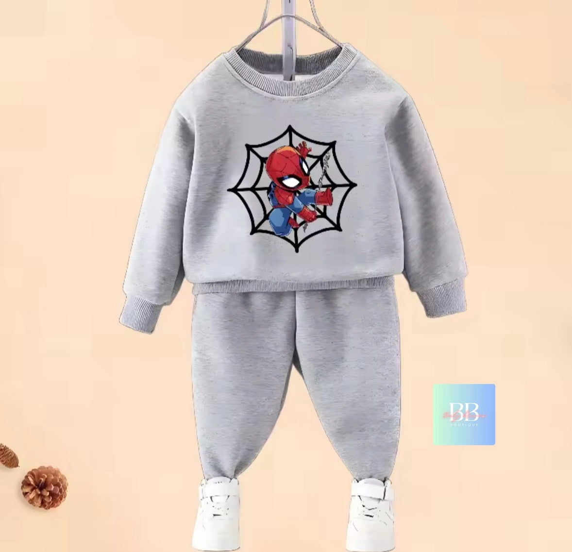 Gray children's sweatshirt and pants set with Spider-Man design on a beige background