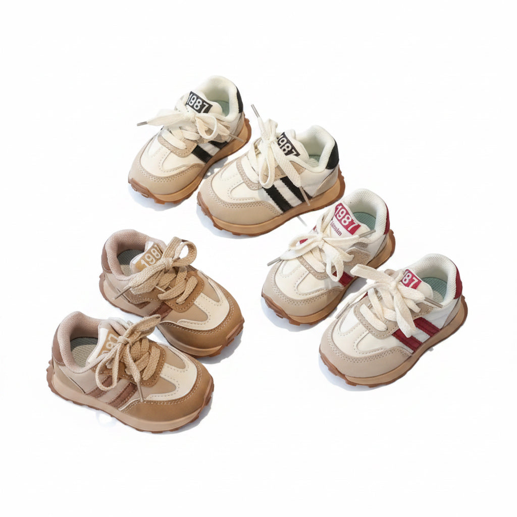 Set of children's sneakers on a gray surface