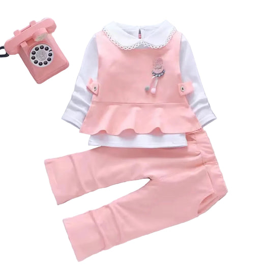 Children's pink outfit with white shirt and pants on a gray background