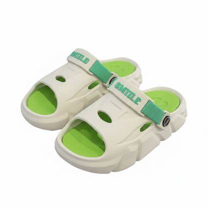 White and green sandals with a brand logo on a dark surface.