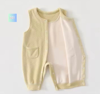 Beige baby romper with a pocket on a white background