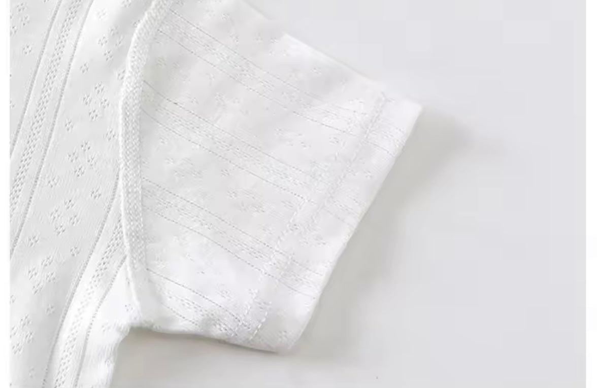 Close-up of a textured white fabric on a light gray background