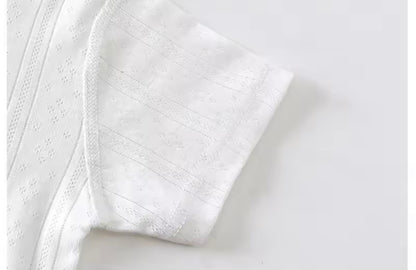 Close-up of a textured white fabric on a light gray background