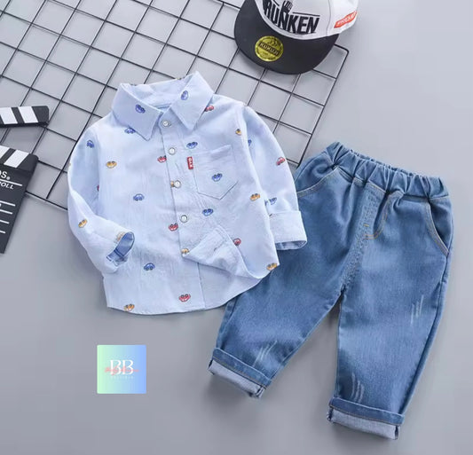 Children's outfit with a patterned shirt and jeans on a grid background