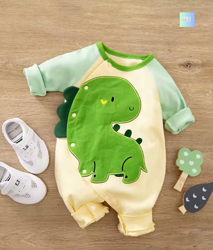 Baby romper with dinosaur design on a wooden surface, accompanied by white shoes and decorative items.