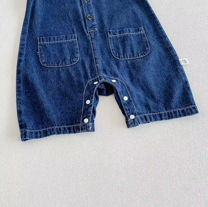 Blue denim baby romper with button details on a light gray background