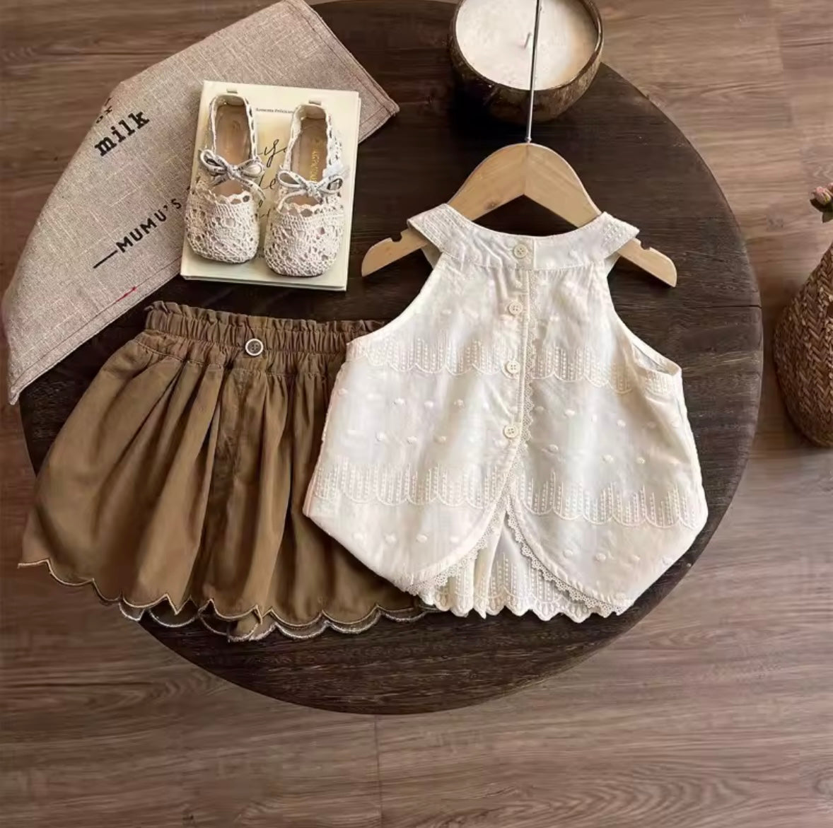 Children's clothing set on a wooden table with a hanger
