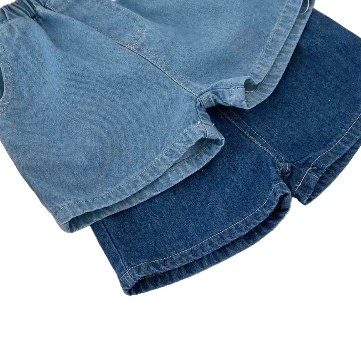 Stack of blue denim shorts on a white background