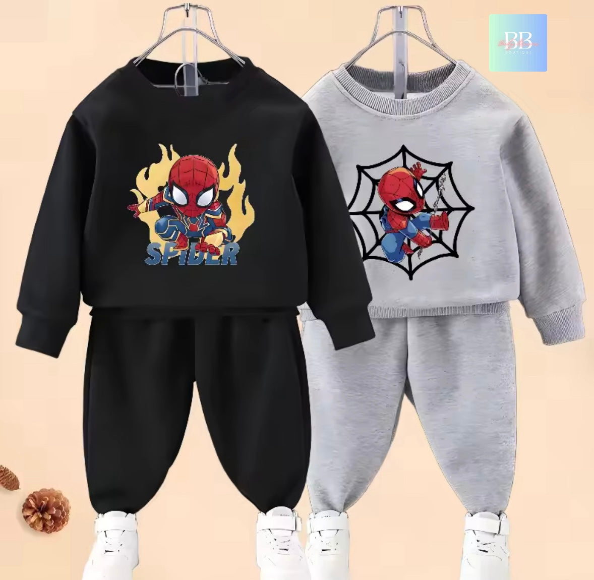 Two children's sweatshirt and pants sets with Spider-Man design on a beige background.