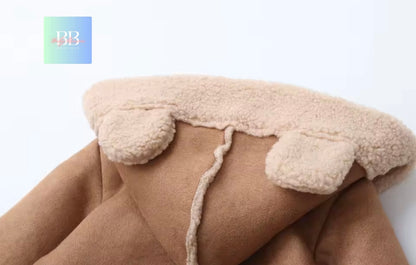 Close-up of a beige blanket with fluffy trim on a white background