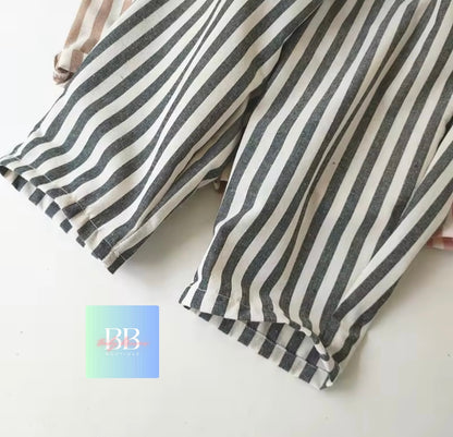 Striped pants with a brand logo in the corner on a light background