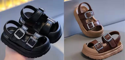 Black and brown children's sandals with buckles on a light background