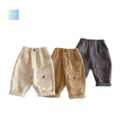 Three pairs of children's pants in beige, brown, and gray on a white background.