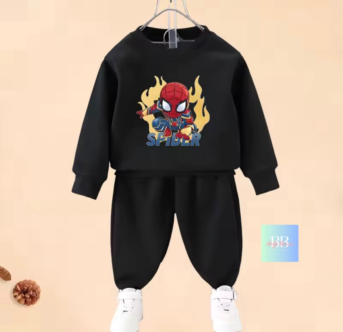 Black children's sweatshirt and pants set with a Spider-Man design on a beige background